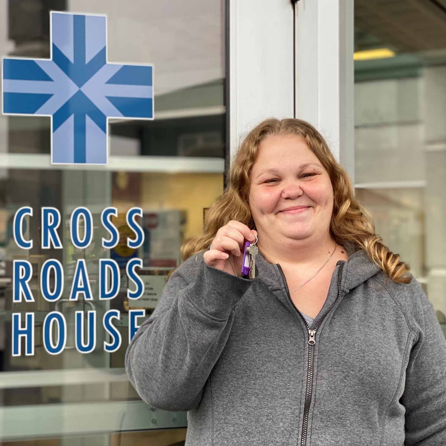 Former Cross Roads House resident Linda with the keys to her new apartment
